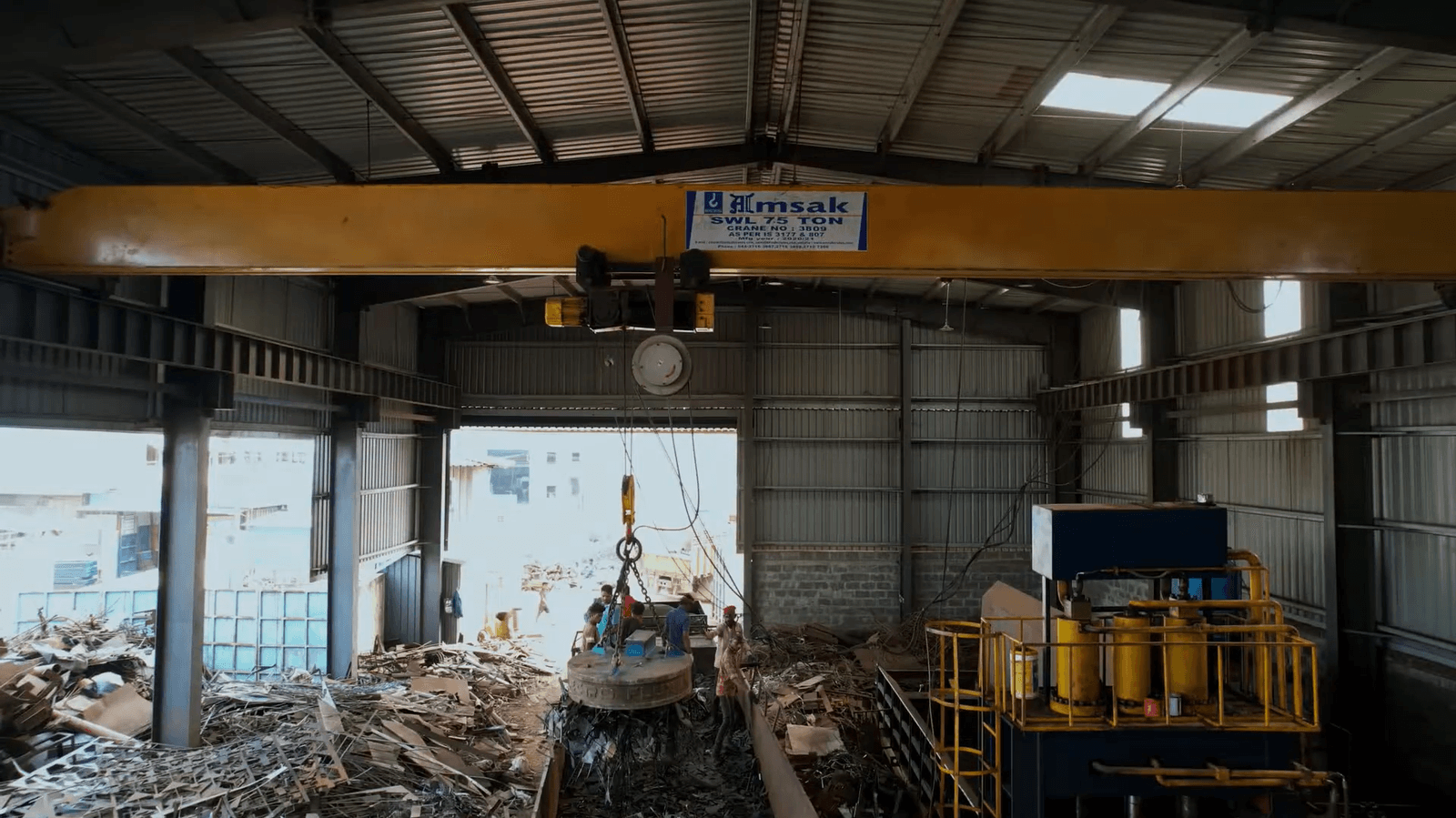 Magnetic crane lifter moving scrap in the yard